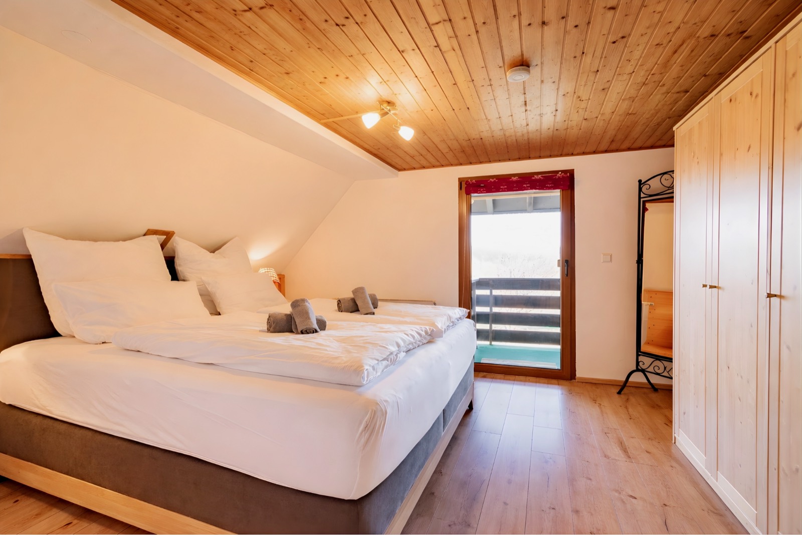 Bedroom with box-spring bed and balcony door